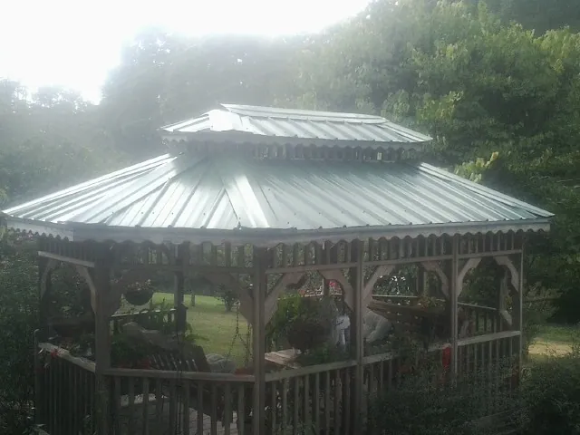 Two tier green metal roof on a garden gazebo in Felicity