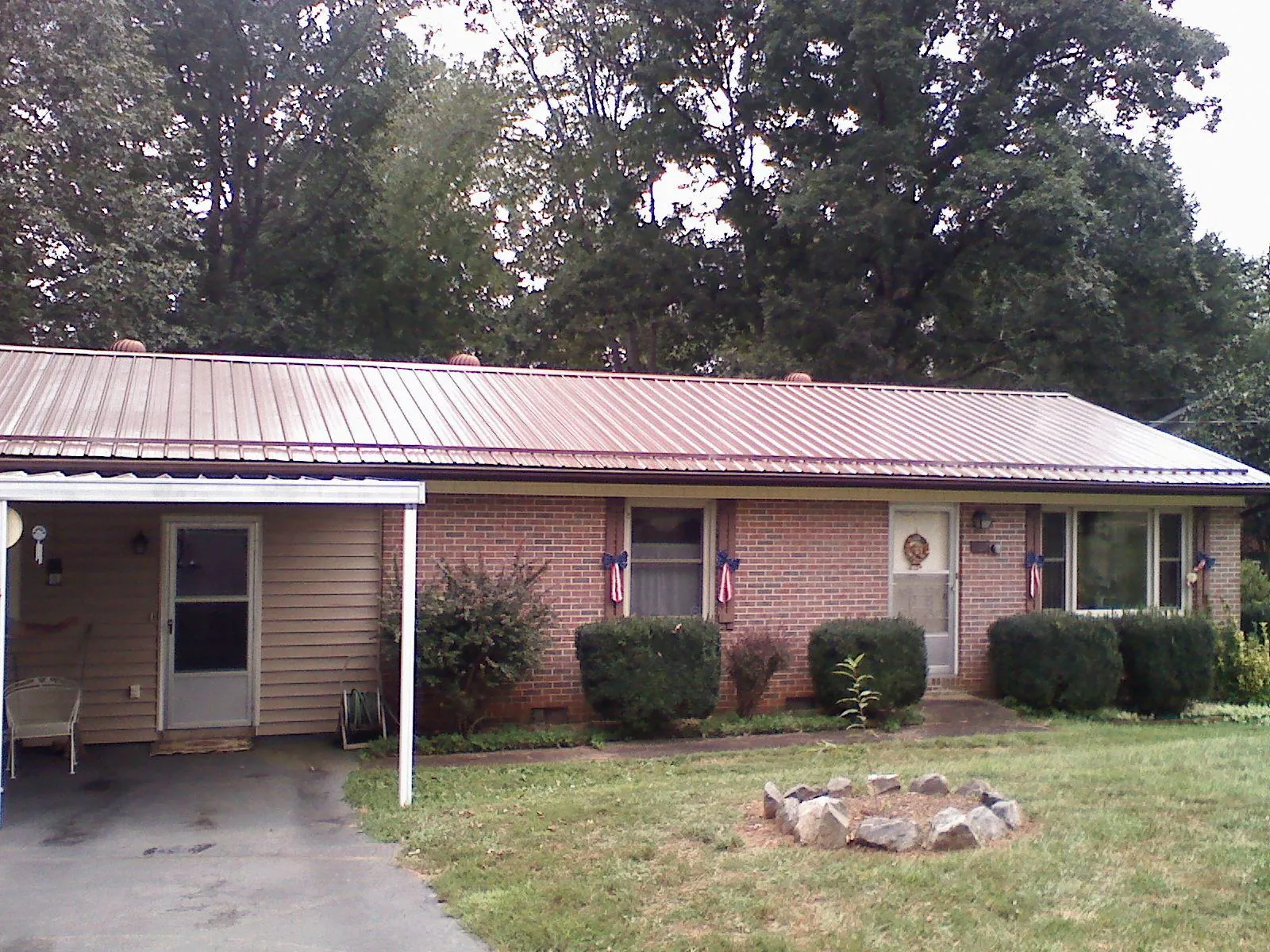 Bronze metal roof and carport on a brick ranch home — Roof Repair work by our crew in Felicity